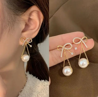 Golden bow hanging earnings