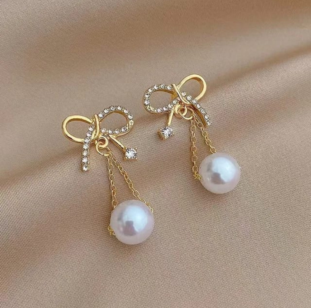 Golden bow hanging earnings