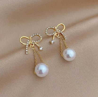 Golden bow hanging earnings